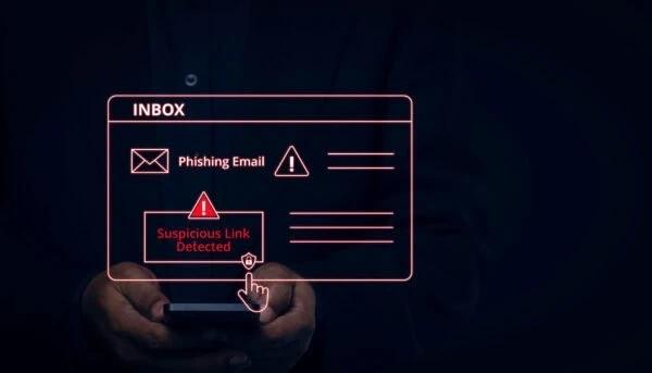 A person holds a smartphone with a virtual inbox display showing phishing email warnings and a "Suspicious Link Detected" alert.