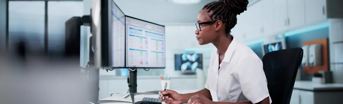 Healthcare professional working at a computer